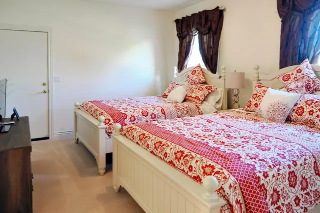 a bedroom with a bed and a dresser