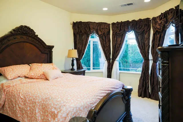 a bedroom with a bed and flat screen tv