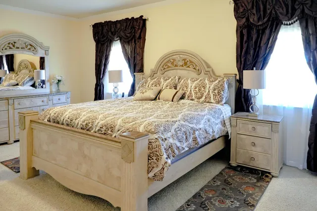 a bedroom with a bed and a window