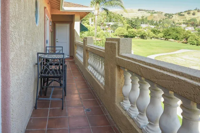 a view of a house with swimming pool lawn chairs and a yard