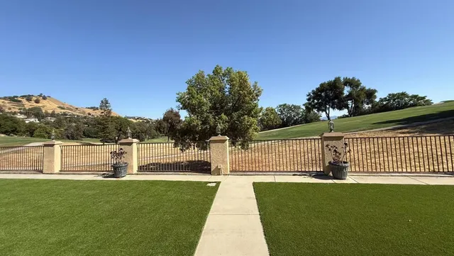 a swimming pool with trees in front of it