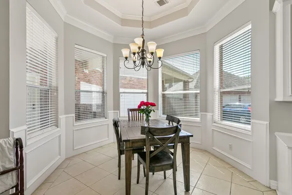 a kitchen with a stove and a white cabinets