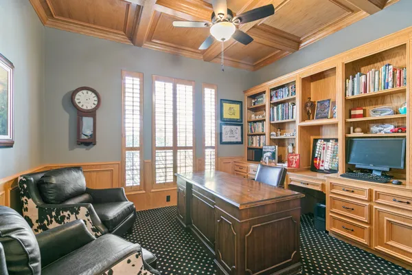 a kitchen with a stove cabinets and chairs