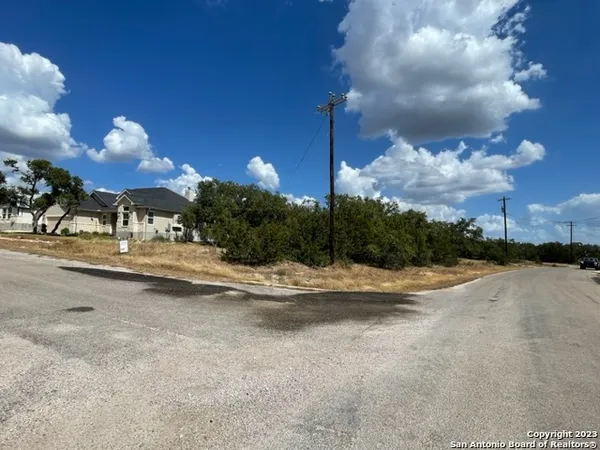 a view of a street with a building in the background