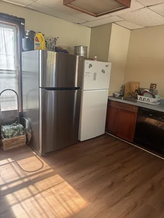a kitchen with a refrigerator and a sink
