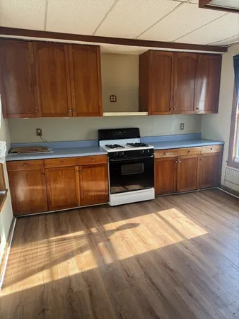 a kitchen with wooden cabinets and a stove top oven
