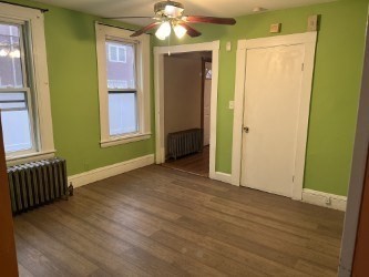 6 Minot Street, Unit 6 Lynn, MA 01905 - Photo 8 of 10 a view of an empty room with wooden floor and a window