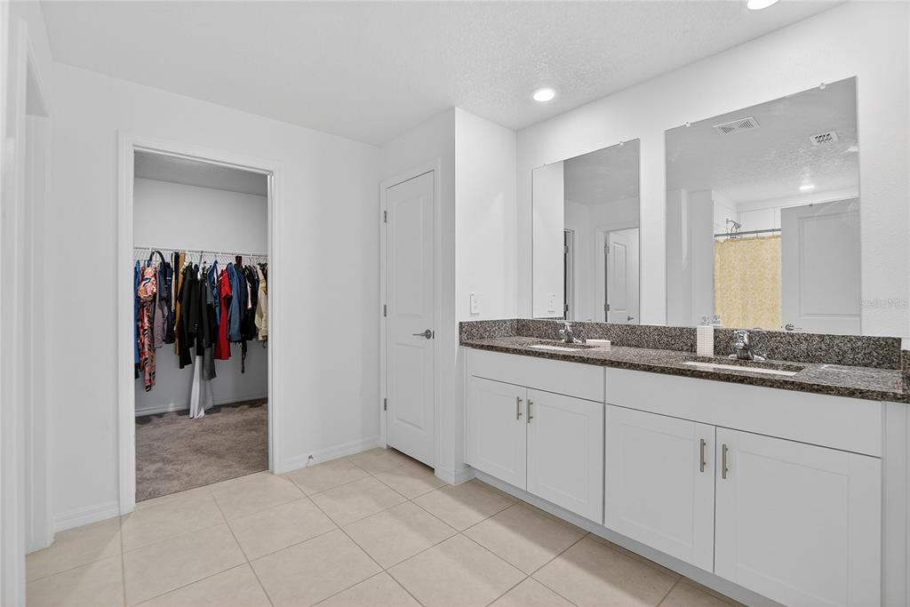 13084 Garnet Raspberry Avenue Wimauma, FL 33598 - Photo 11 of 20 a bathroom with a sink and a mirror