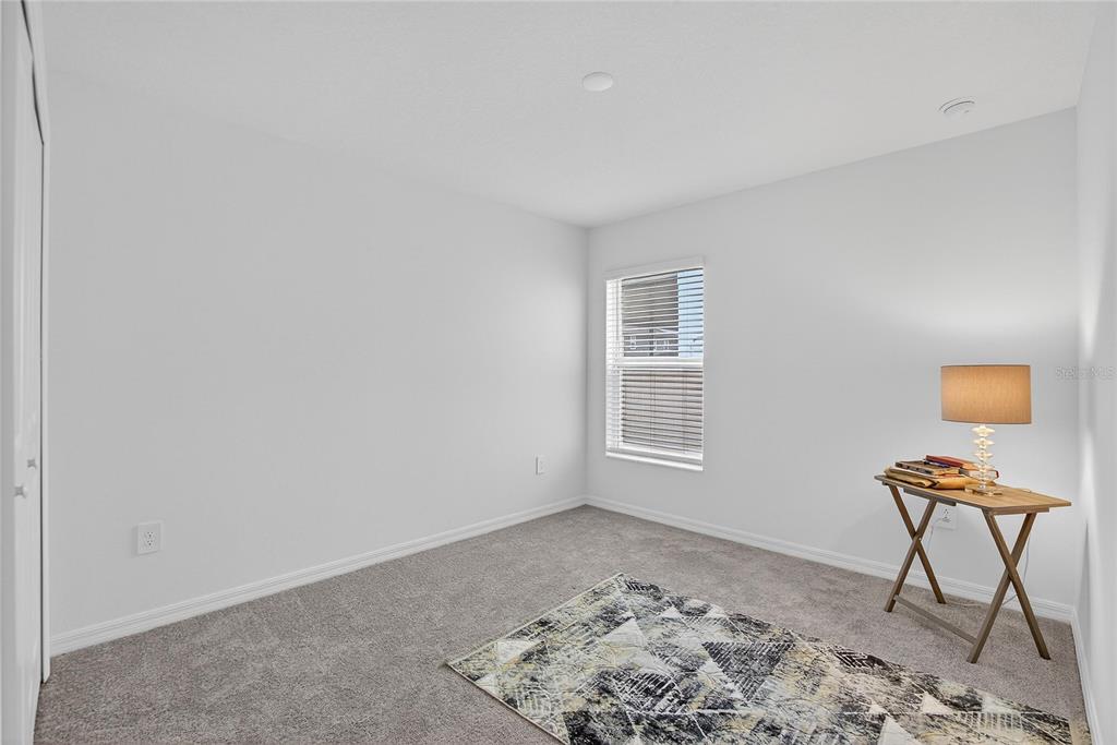 13084 Garnet Raspberry Avenue Wimauma, FL 33598 - Photo 14 of 20 a view of a livingroom with wooden floor and a window