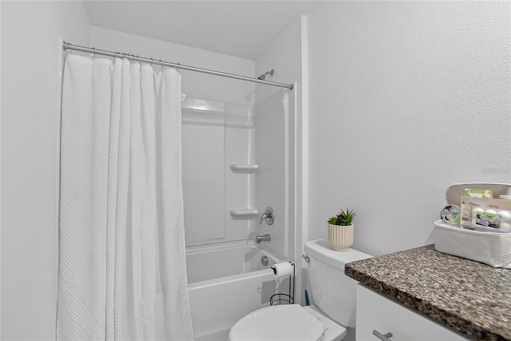 13084 Garnet Raspberry Avenue Wimauma, FL 33598 - Photo 16 of 20 a bathroom with a granite countertop sink and a mirror