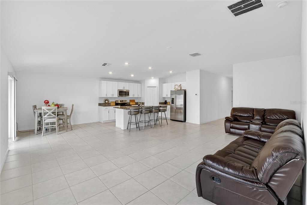 13084 Garnet Raspberry Avenue Wimauma, FL 33598 - Photo 7 of 20 a living room with furniture and a flat screen tv