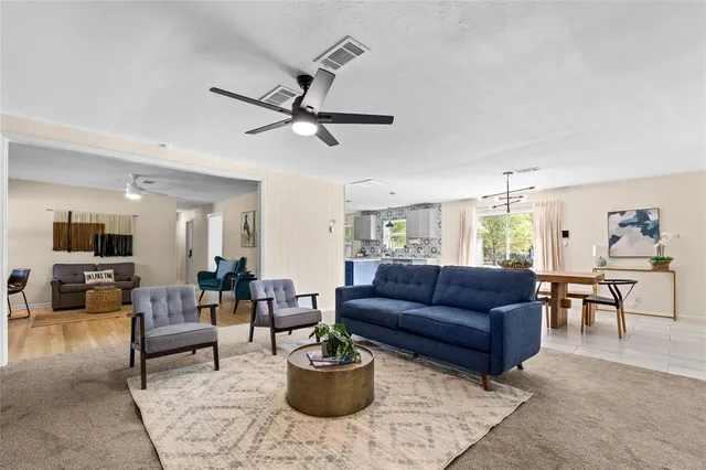 a living room with furniture a rug and a chandelier
