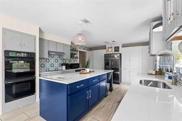 a kitchen with a sink stove and refrigerator