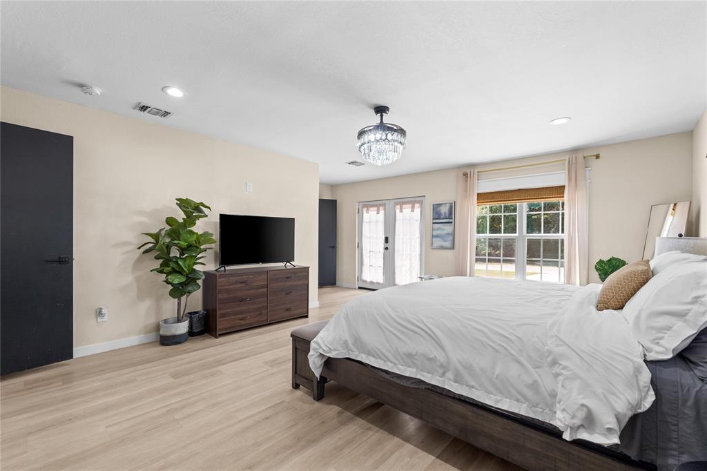 1933 Walter Smith Road Azle, TX 76020 - Photo 21 of 40 a bedroom with a large bed and a potted plant