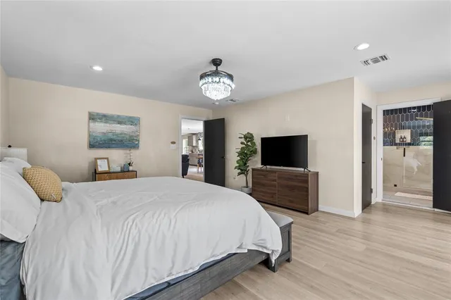 a bedroom with a bed and a flat screen tv