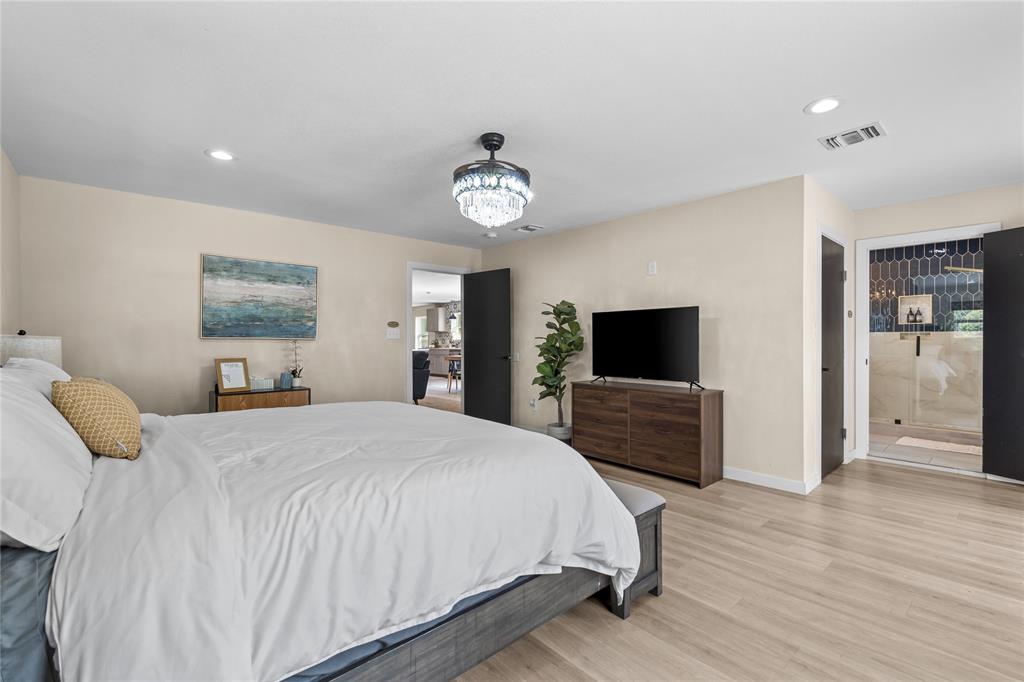 1933 Walter Smith Road Azle, TX 76020 - Photo 22 of 40 a bedroom with a bed and a flat screen tv