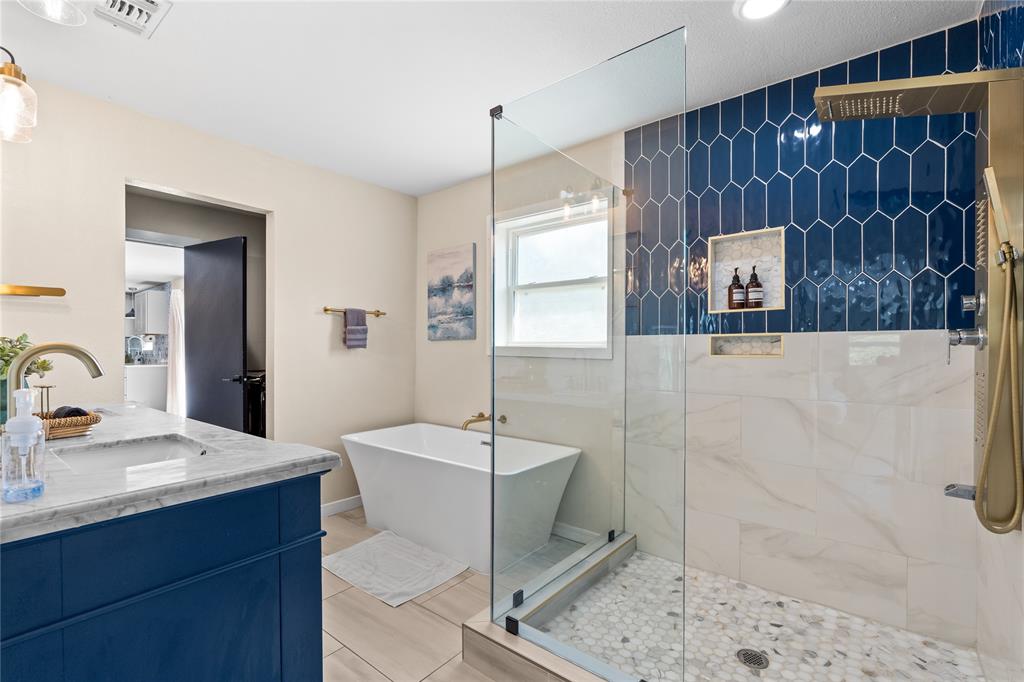 1933 Walter Smith Road Azle, TX 76020 - Photo 25 of 40 a bathroom with a sink a mirror and shower