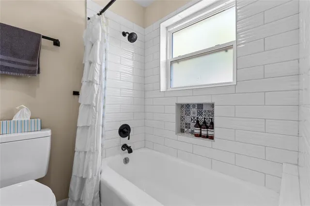 a bathroom with a toilet and a bathtub