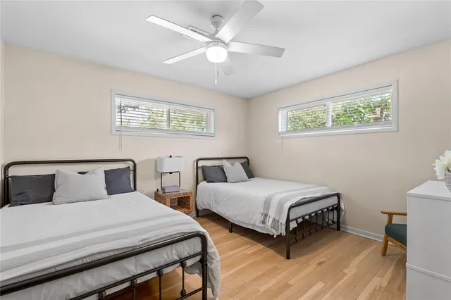 a bedroom with two beds and a chandelier