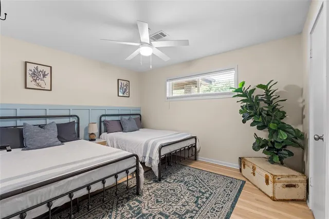 a bedroom with a large bed and a potted plant