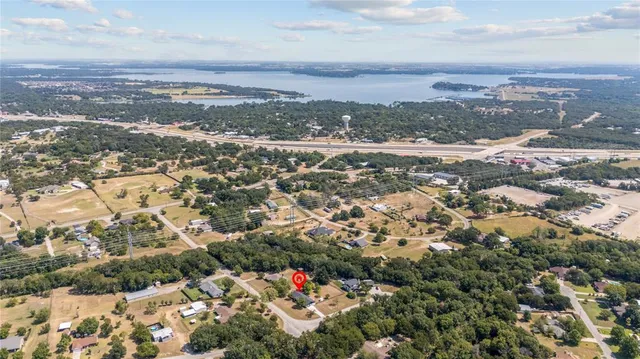 an aerial view of residential houses with city view
