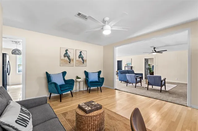 a living room with furniture and wooden floor
