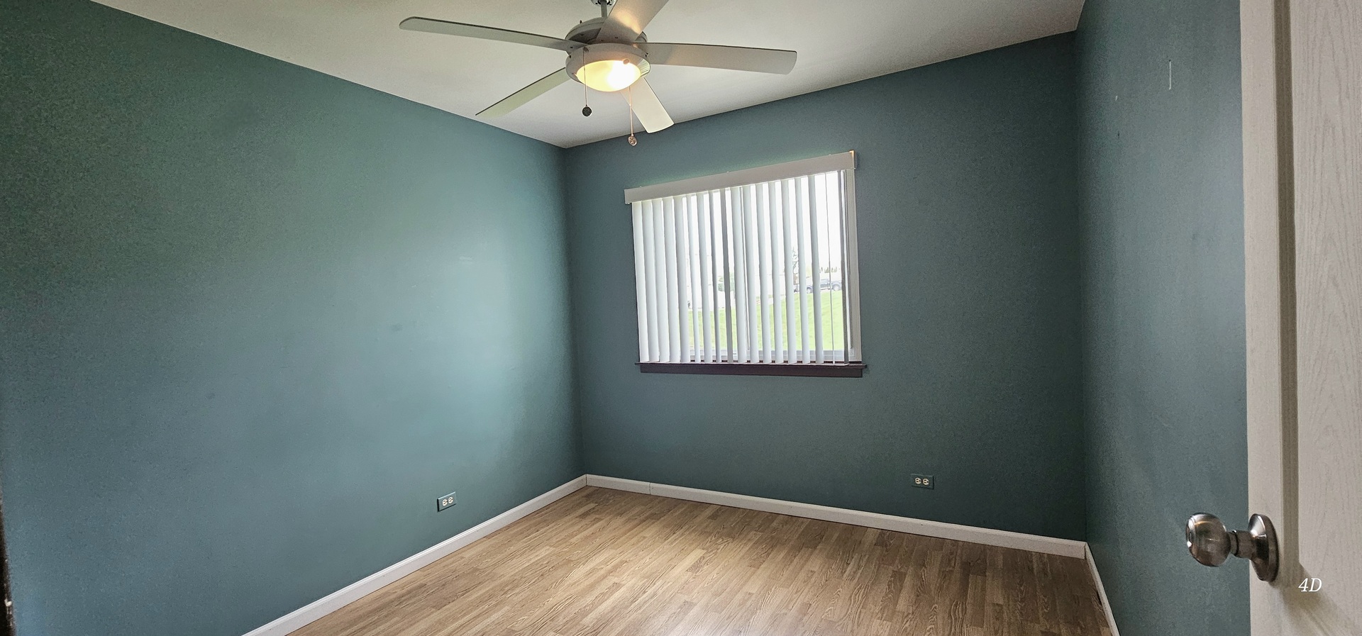 1497 Cornell Court Hoffman Estates, IL 60169 - Photo 17 of 30 an empty room with a window and a fan