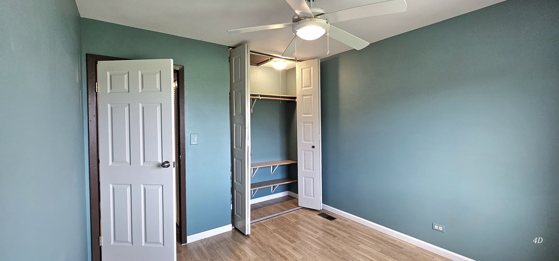1497 Cornell Court Hoffman Estates, IL 60169 - Photo 18 of 30 a view of an empty room with wooden floor and a window
