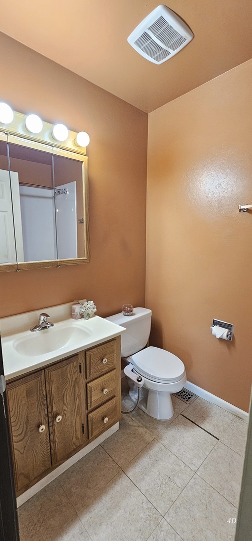 1497 Cornell Court Hoffman Estates, IL 60169 - Photo 19 of 30 a bathroom with a sink a toilet and mirror