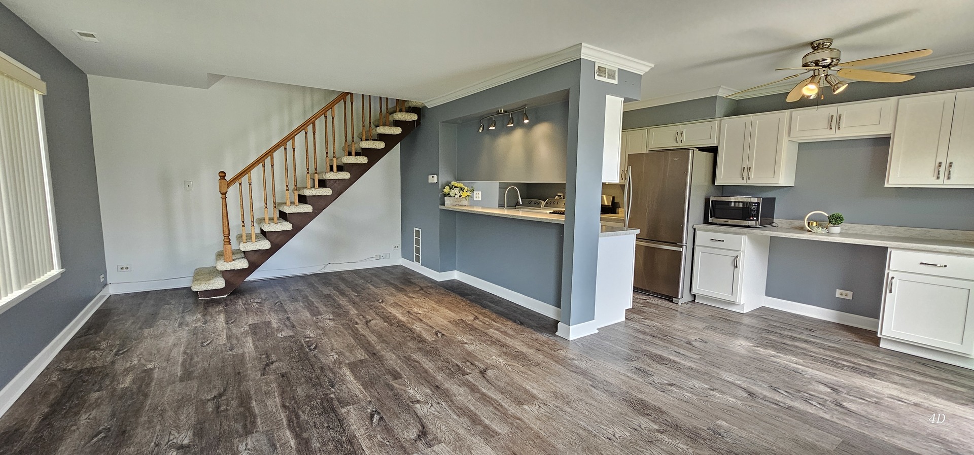 1497 Cornell Court Hoffman Estates, IL 60169 - Photo 4 of 30 a view of a kitchen with wooden floor electronic appliances and stairs