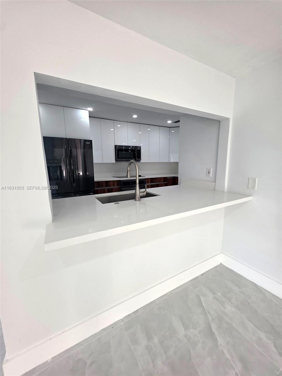 Davie Davie, FL 33314 - Photo 14 of 44 a view of kitchen with microwave and cabinets