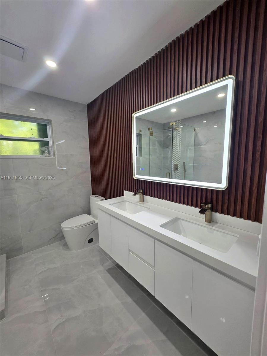 Davie Davie, FL 33314 - Photo 17 of 44 a bathroom with a sink and a mirror