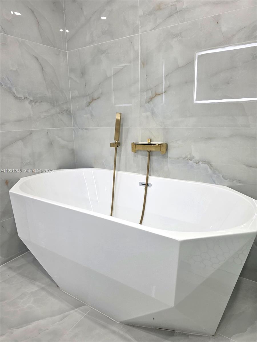 Davie Davie, FL 33314 - Photo 20 of 44 a white bath tub sitting in a bathroom