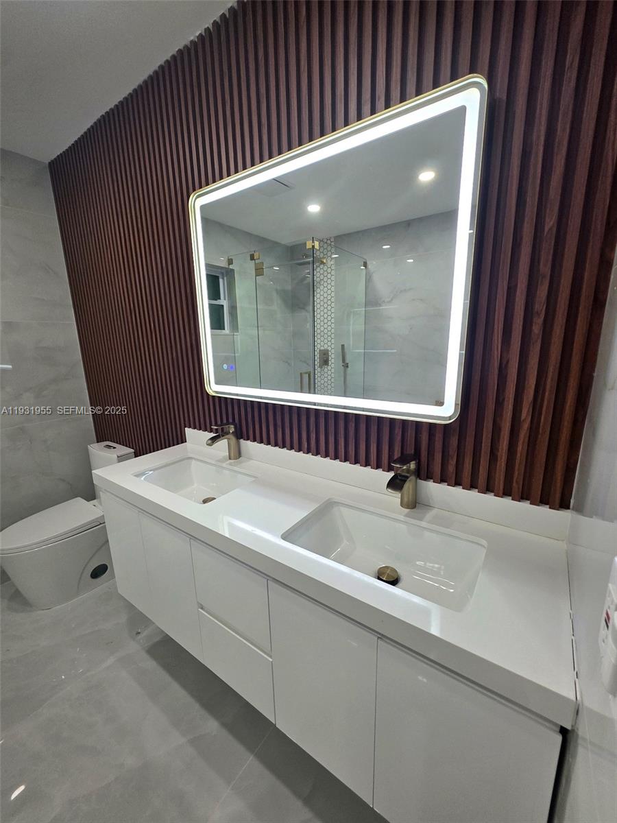 Davie Davie, FL 33314 - Photo 23 of 44 a bathroom with a bathtub and a sink