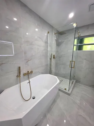 a bathroom with a bathtub and a shower
