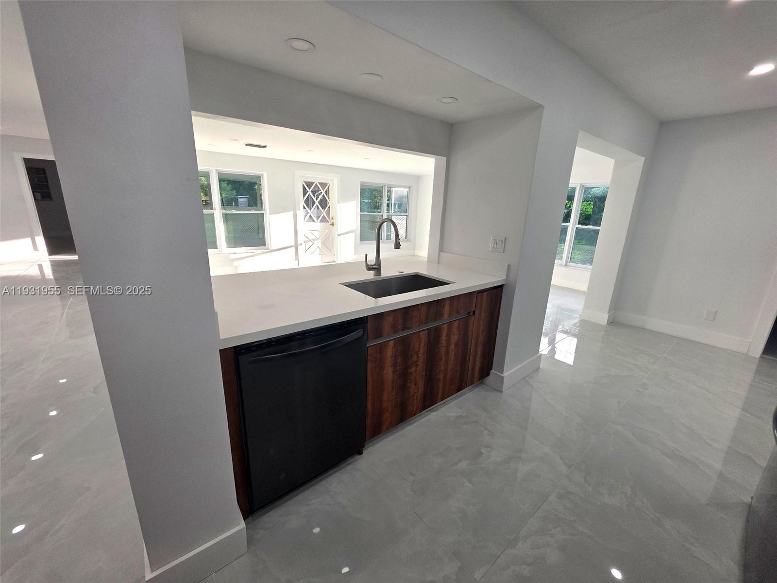 Davie Davie, FL 33314 - Photo 6 of 44 a kitchen with a sink a window and cabinets