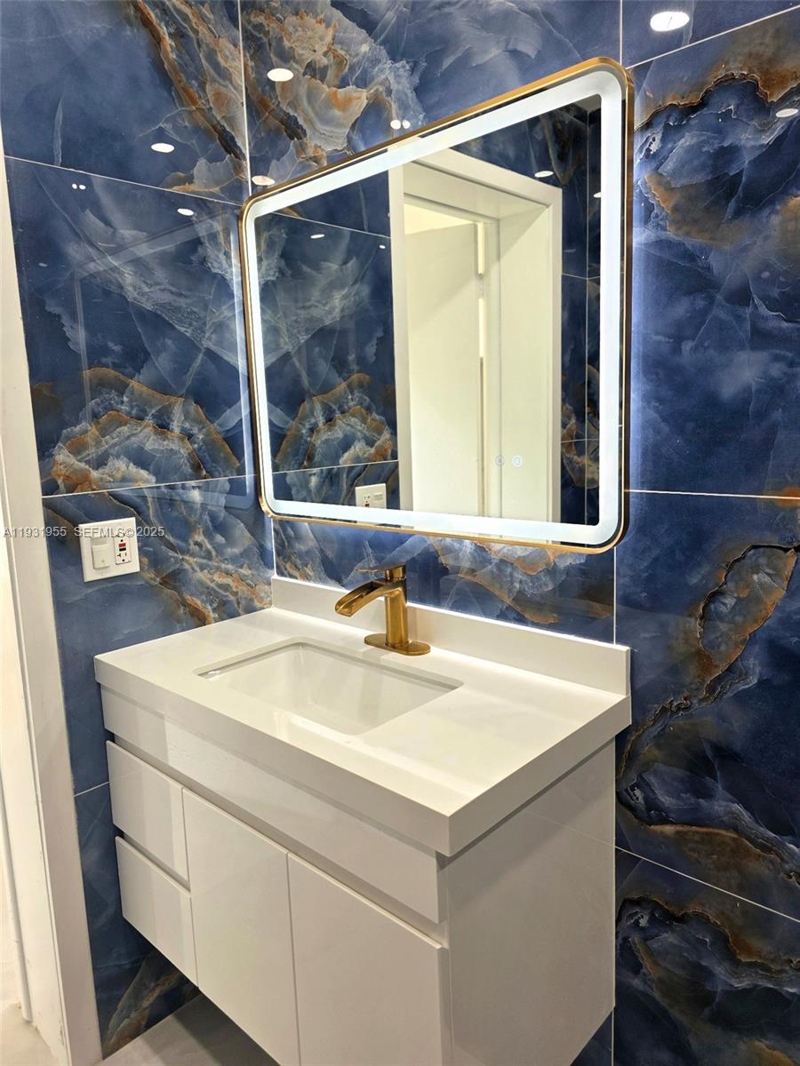 Davie Davie, FL 33314 - Photo 10 of 44 a bathroom with a sink and a mirror