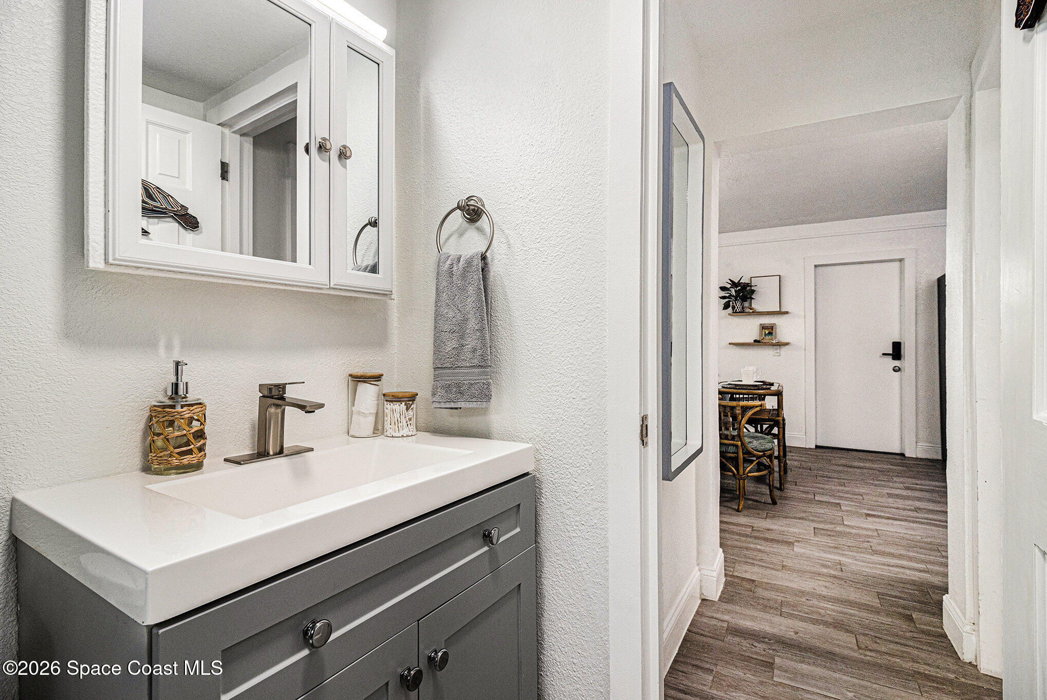 7605 Ridgewood Avenue, Unit 3 Cape Canaveral, FL 32920 - Photo 11 of 28 a bathroom with a sink a mirror and shower