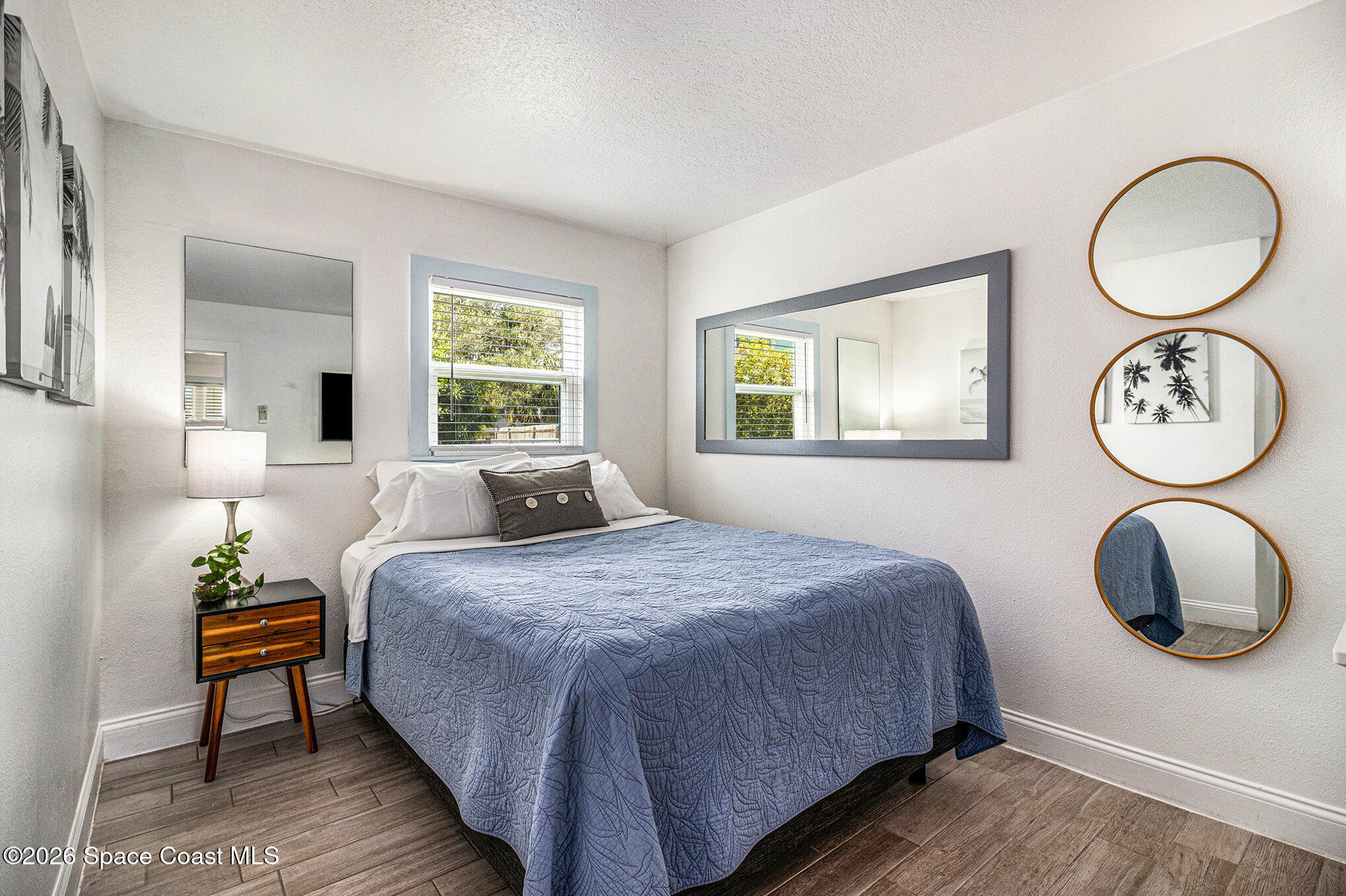 7605 Ridgewood Avenue, Unit 3 Cape Canaveral, FL 32920 - Photo 12 of 28 a bedroom with a bed and a window