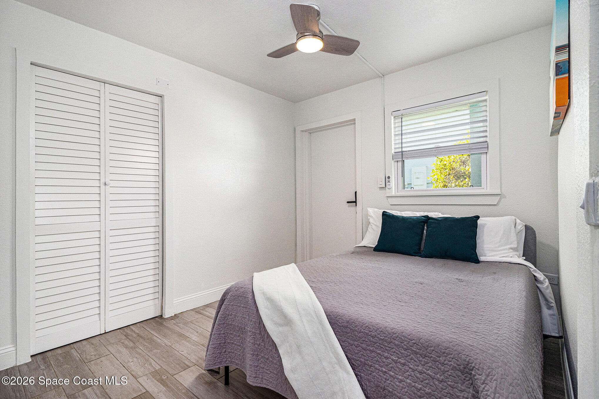 7605 Ridgewood Avenue, Unit 3 Cape Canaveral, FL 32920 - Photo 16 of 28 a bedroom with a bed and a window