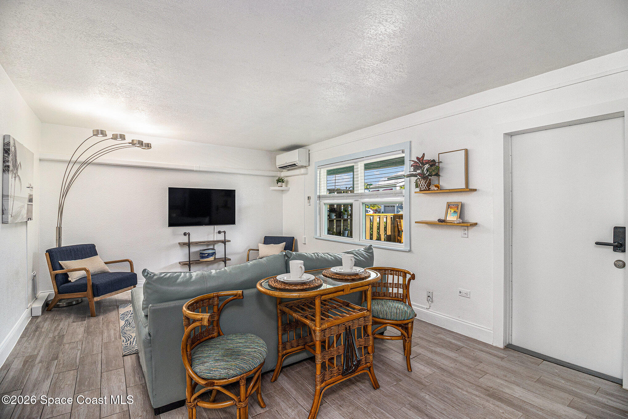 7605 Ridgewood Avenue, Unit 3 Cape Canaveral, FL 32920 - Photo 19 of 28 a living room with furniture and a flat screen tv