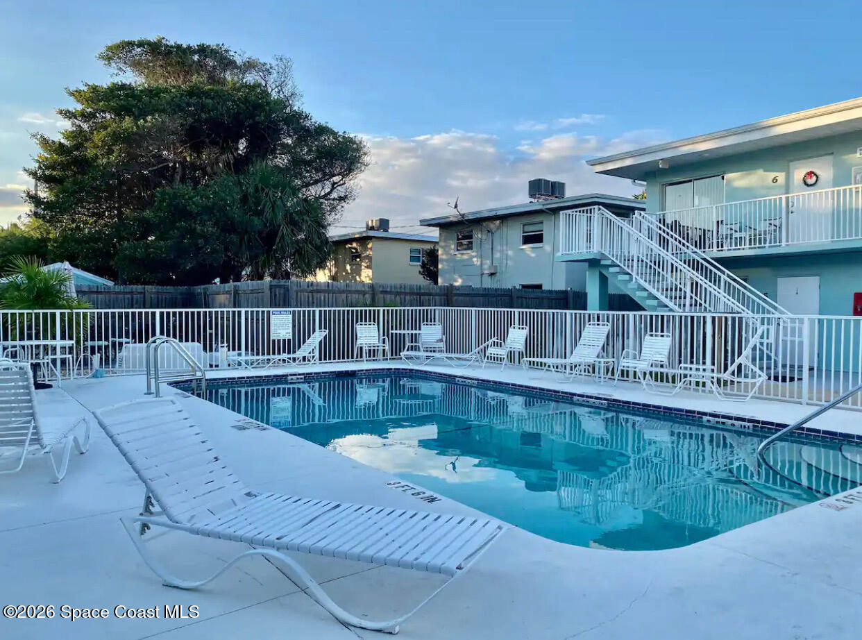 7605 Ridgewood Avenue, Unit 3 Cape Canaveral, FL 32920 - Photo 25 of 28 a view of a swimming pool with deck
