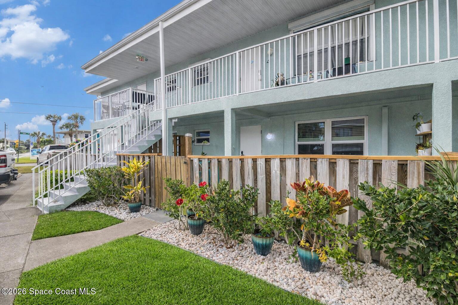 7605 Ridgewood Avenue, Unit 3 Cape Canaveral, FL 32920 - Photo 28 of 28 a front view of a house with a yard