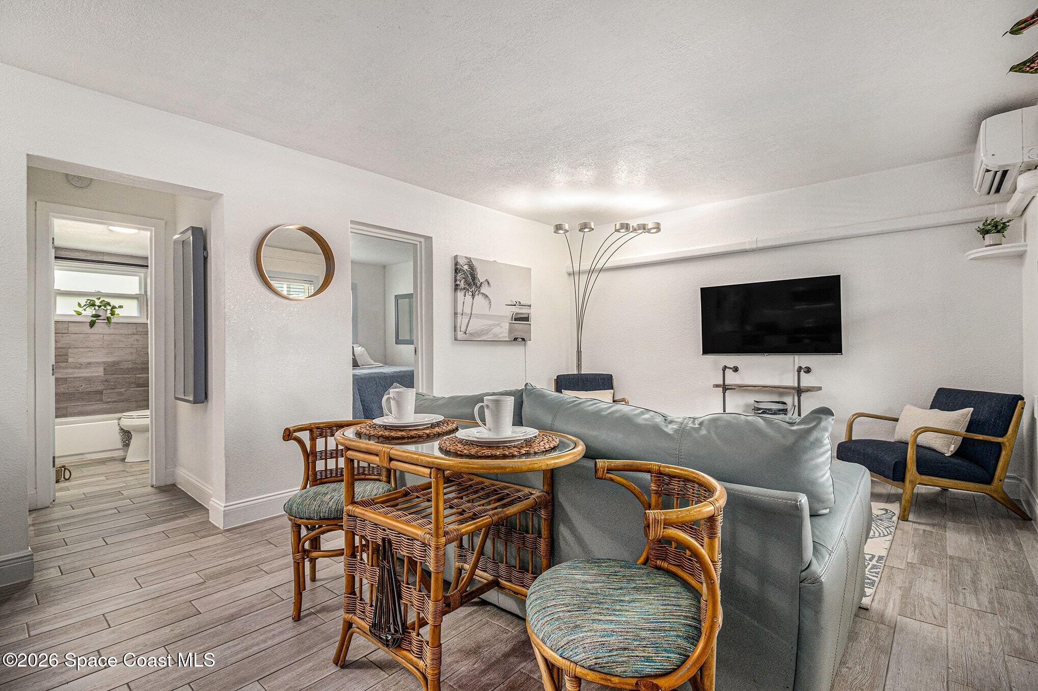 7605 Ridgewood Avenue, Unit 3 Cape Canaveral, FL 32920 - Photo 7 of 28 a view of a dining room with furniture and wooden floor