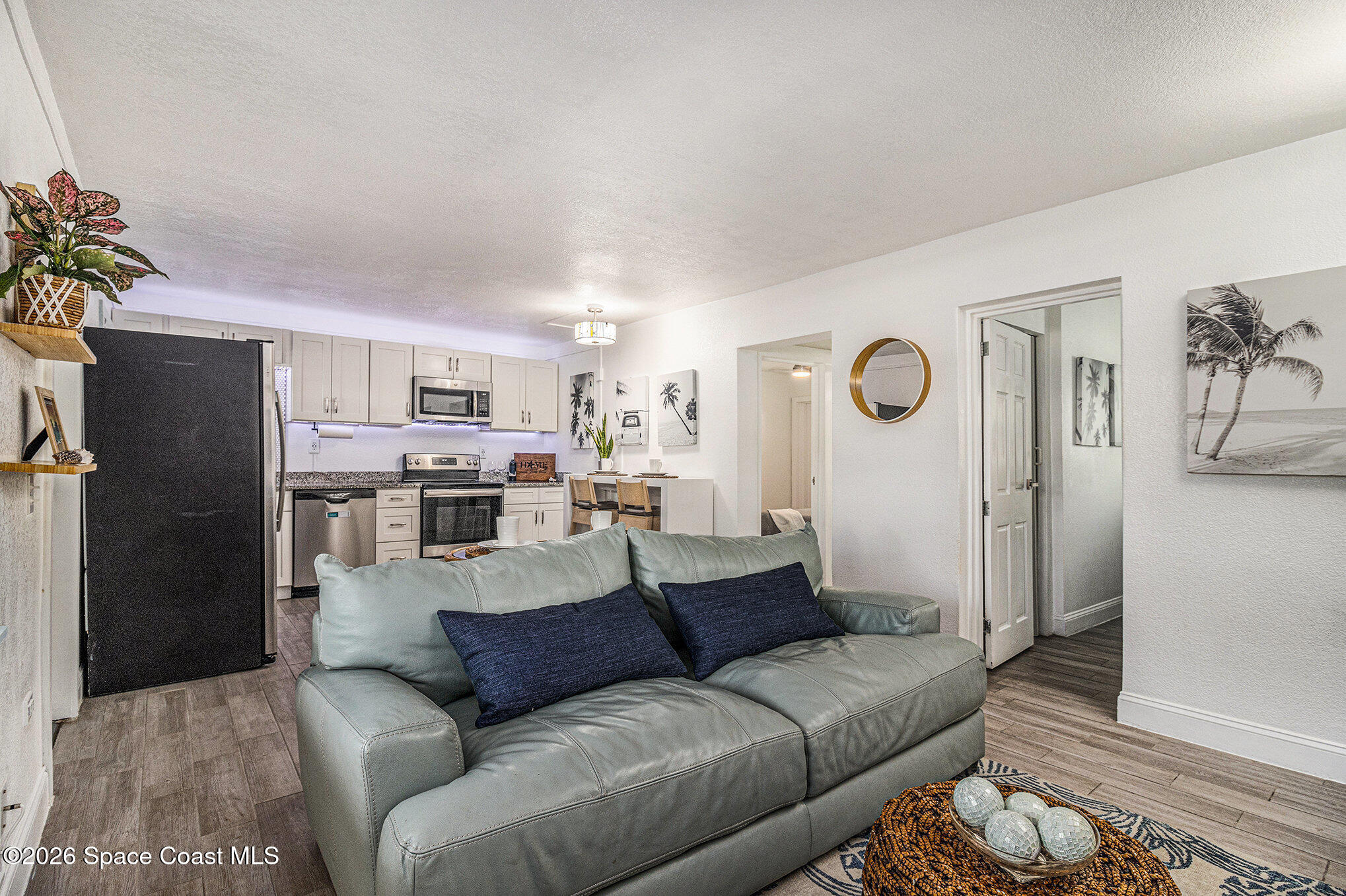 7605 Ridgewood Avenue, Unit 3 Cape Canaveral, FL 32920 - Photo 9 of 28 a living room with stainless steel appliances furniture and a view of kitchen