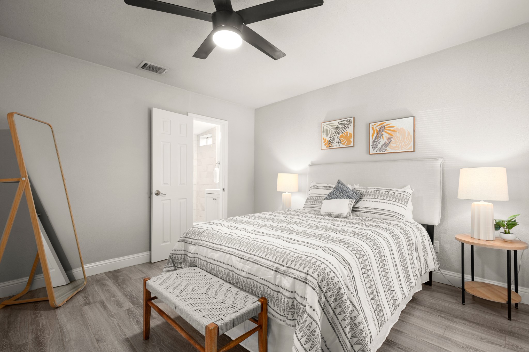 918 West 3rd Street Taylor, TX 76574 - Photo 12 of 22 Bedroom with light wood-type flooring, a ceiling fan, and ensuite bath
