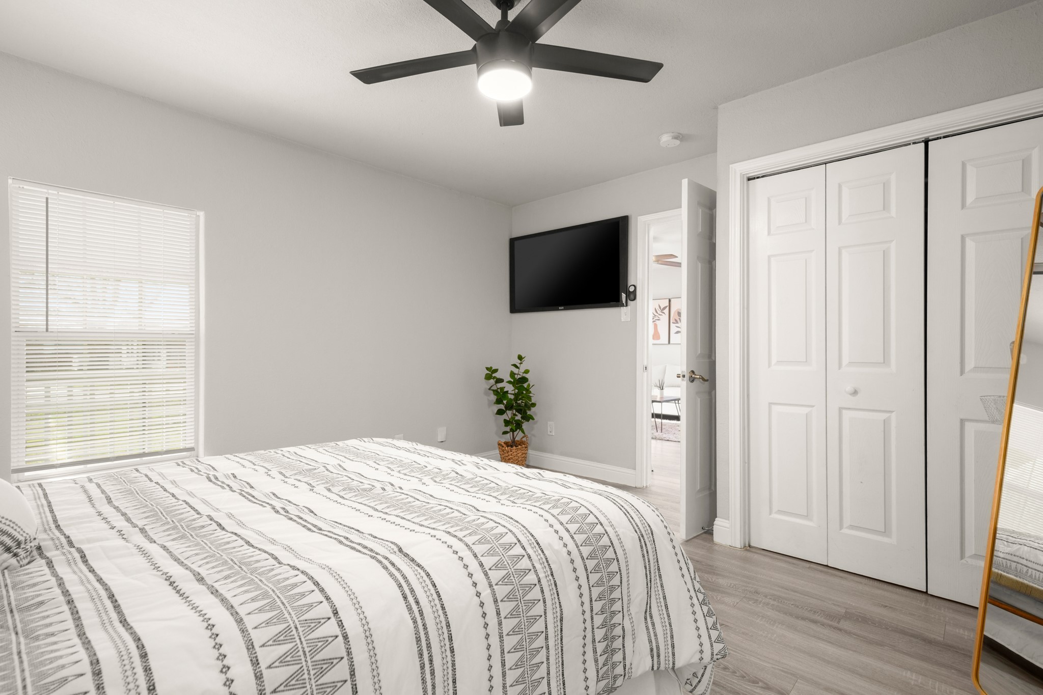 918 West 3rd Street Taylor, TX 76574 - Photo 13 of 22 Bedroom featuring light wood finished floors, a ceiling fan, and a closet