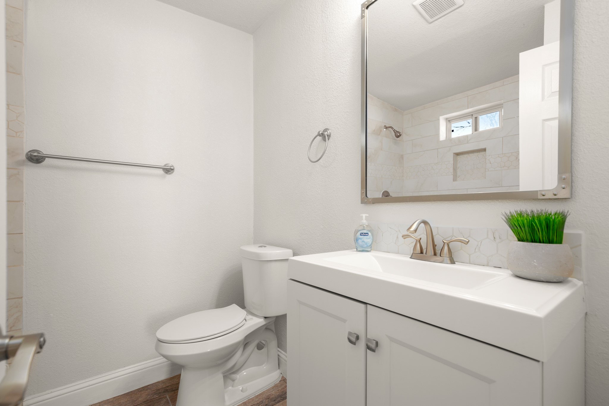 918 West 3rd Street Taylor, TX 76574 - Photo 17 of 22 Full bath with vanity, a textured wall, and wood finished floors