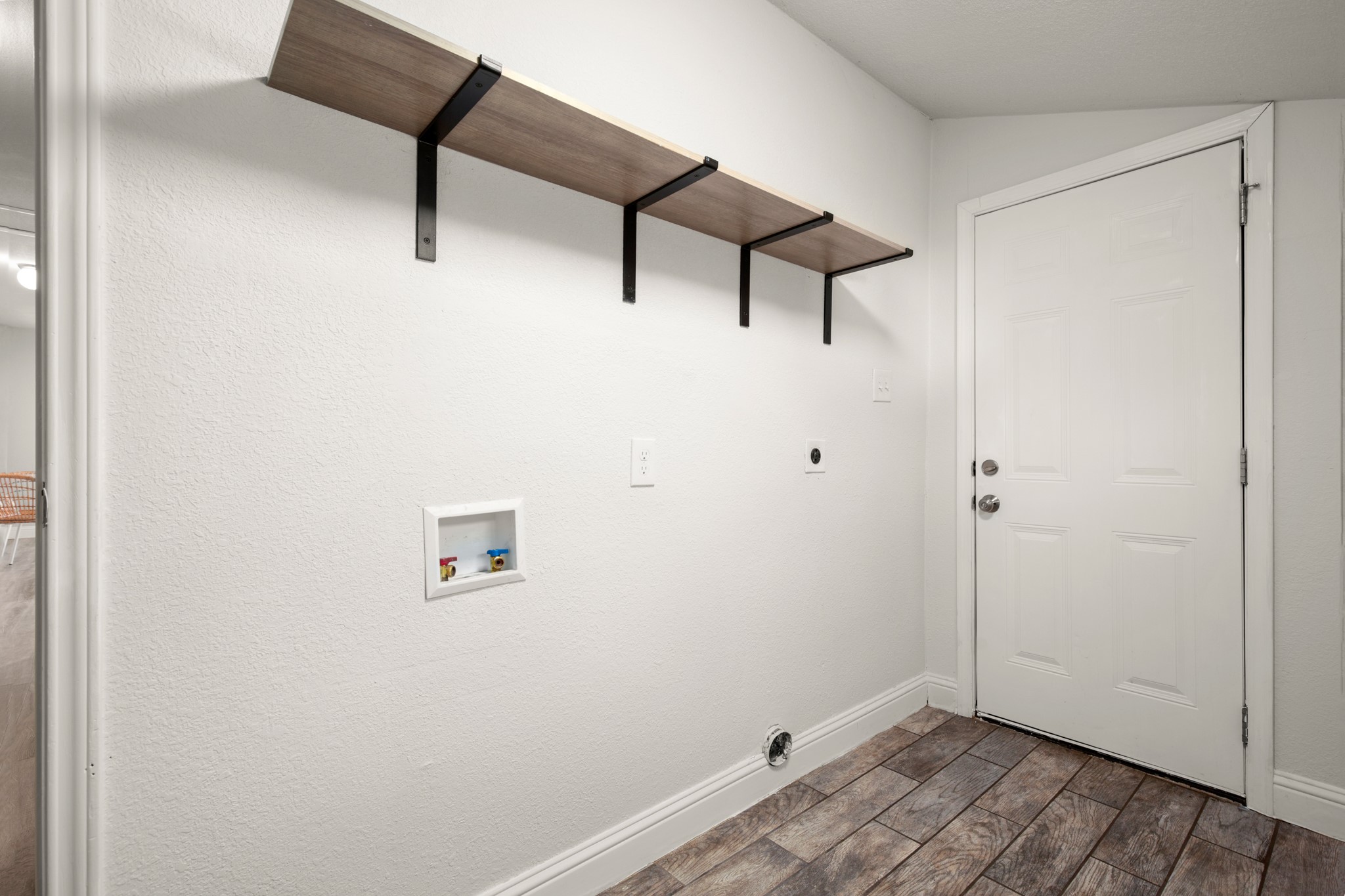 918 West 3rd Street Taylor, TX 76574 - Photo 19 of 22 Laundry area with wood finish floors, hookup for a washing machine, and electric dryer hookup