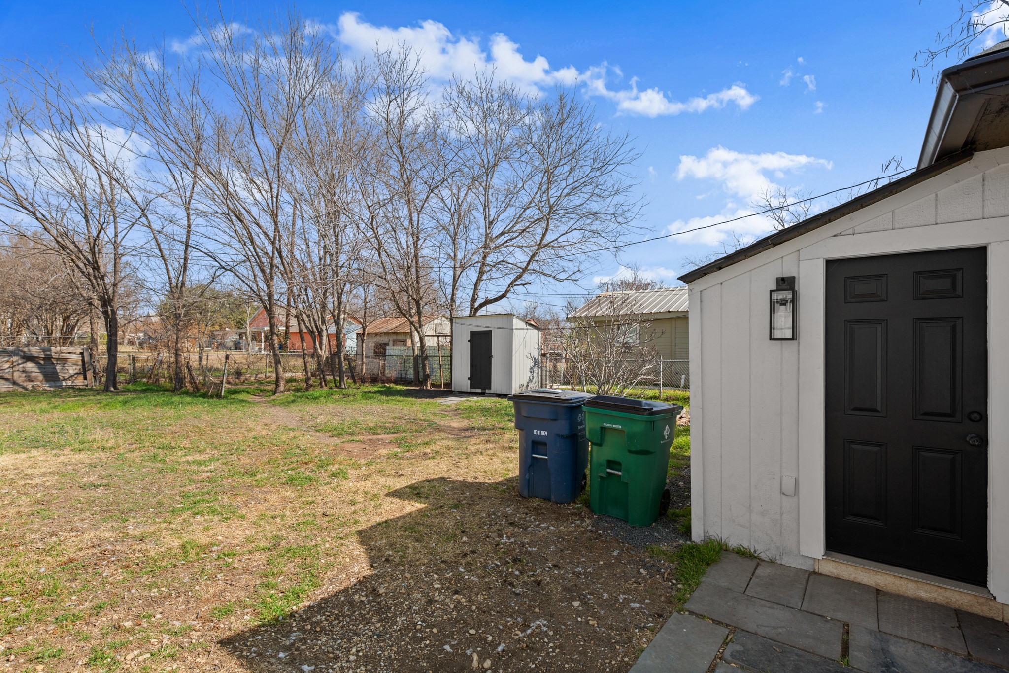 918 West 3rd Street Taylor, TX 76574 - Photo 20 of 22 Fenced yard featuring a storage unit